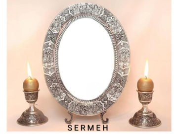 Silver Persian mirror and candle holder